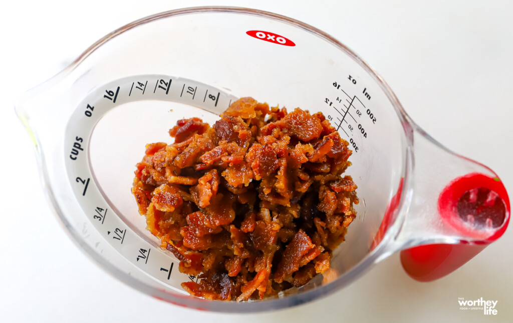 chopped bacon in a measuring cup