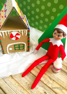 Elf Builds A Cardboard Gingerbread House