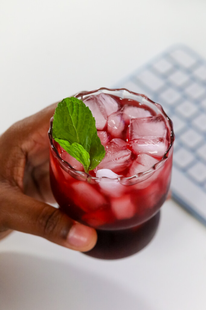 a woman holding a wellness mocktail