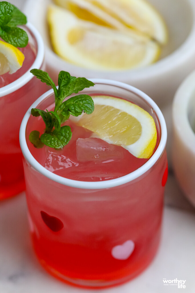 pink drink for galentine's in a heart shaped glass